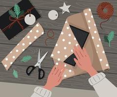 The process of wrapping christmas gifts. Wrapping paper, scissors in flat style vector