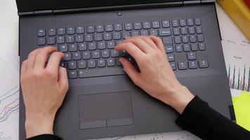 Woman hands typing on laptop, business and finance video