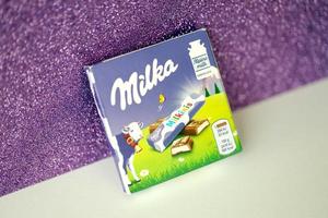 TERNOPIL, UKRAINE - JUNE 3, 2022 Milka milkinis small pack with chocolate finger bars. Milka is a Swiss brand of chocolate confection manufactured by company Mondelez International photo