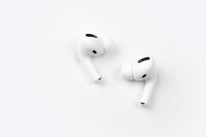 KHARKIV, UKRAINE - JANUARY 27, 2022 Apple AirPods Pro on a white background. Wireless headphones. Apple Inc. is an American technology company photo