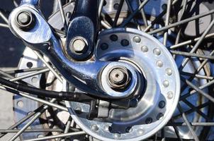 Fragment of chromed shiny wheel of old classic motorbike photo