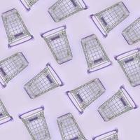 Pattern of many small shopping carts on a violet background. Minimalism flat lay top view photo