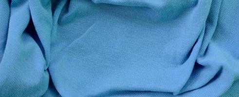 The texture of the fabric in blue color. Material for making shirts and blouses photo