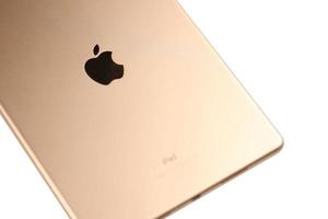 KHARKIV, UKRAINE - JANUARY 27, 2022 Brand new Apple iPad golden body surface with company logo on white background. Apple Inc. is an American technology company photo