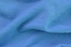 The texture of the fabric in blue color. Material for making shirts and blouses photo