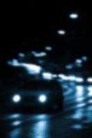 Blurred night scene of traffic on the roadway. Defocused image of cars traveling with luminous headlights. Bokeh Art photo