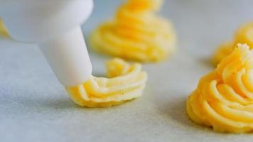 The chef makes potato cookies using a food bag. Potato cookies canonic recipe Brie, parmesan and Heavy cream. Macro shooting video