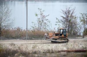 Quarry aggregate with heavy duty machinery. Caterpillar loader Excavator with backhoe driving to construction site quarry photo