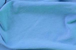 The texture of the fabric in blue color. Material for making shirts and blouses photo