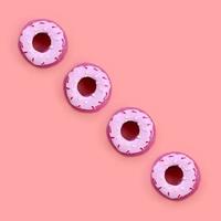 Many small plastic donuts lies on a pastel colorful background. Flat lay minimal pattern. Top view photo