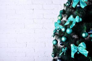 Detailed photo of the Christmas tree on white brick wall