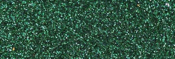Colorful defocused emerald green background with glittering and sparkling spots photo