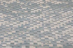 Background mosaic texture of flat roof tiles with bituminous coating photo