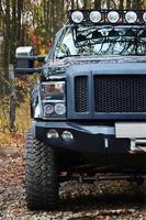 Off-road car on the background of autumn trees photo