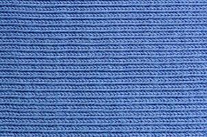 The texture of the fabric in blue color. Material for making shirts and blouses photo