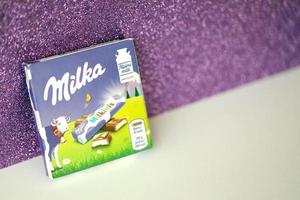 TERNOPIL, UKRAINE - JUNE 3, 2022 Milka milkinis small pack with chocolate finger bars. Milka is a Swiss brand of chocolate confection manufactured by company Mondelez International photo