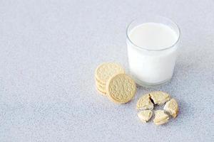 TERNOPIL, UKRAINE - MAY 28, 2022 Oreo golden crispy cookies with glass of milk on white background. The brand Oreo is owned by company Mondelez international photo