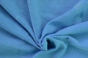 The texture of the fabric in blue color. Material for making shirts and blouses photo