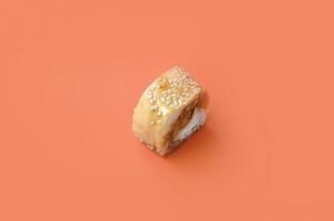 Tori Katsu sushi Roll Maki with processed cheese on orange background. Minimalism top view flat lay with Japanese food photo