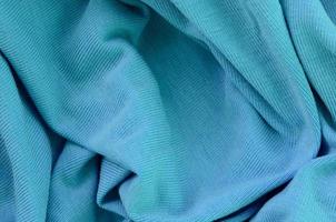 The texture of the fabric in blue color. Material for making shirts and blouses photo