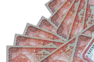 Los billetes de 20 rupias nepalíes se encuentran en diferente orden aislados en blanco. concepto de banca local o hacer dinero foto