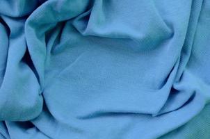 The texture of the fabric in blue color. Material for making shirts and blouses photo