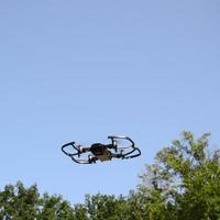 Drone with photocamera take off from land and flying for take aerial photo