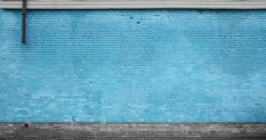 The texture of the brick wall of many rows of bricks painted in blue color photo