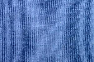 The texture of the fabric in blue color. Material for making shirts and blouses photo