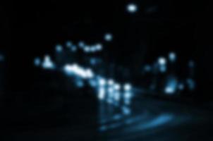 Blurred night scene of traffic on the roadway. Defocused image of cars traveling with luminous headlights. Bokeh Art photo