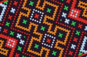 Traditional Ukrainian folk art knitted embroidery pattern on textile fabric photo