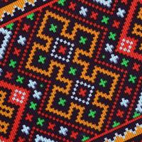 Traditional Ukrainian folk art knitted embroidery pattern on textile fabric photo