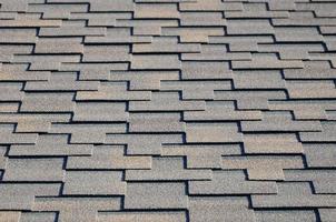 Modern roofing and decoration of chimneys. Flexible bitumen or slate shingles photo