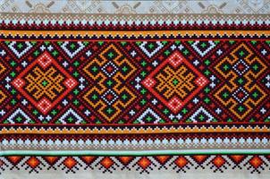 Traditional Ukrainian folk art knitted embroidery pattern on textile fabric photo