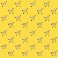 Shopping addiction, shopping lover or shopaholic concept. Many small empty shopping carts perform a pattern on a pastel colored paper background. Flat lay composition, top view photo