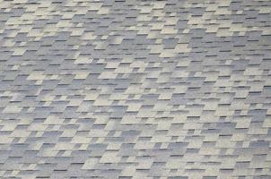 Background mosaic texture of flat roof tiles with bituminous coating photo