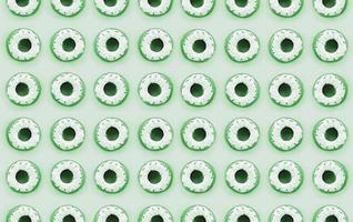 Many small plastic donuts lies on a pastel colorful background. Flat lay minimal pattern. Top view photo