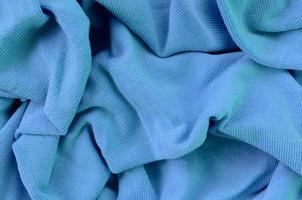 The texture of the fabric in blue color. Material for making shirts and blouses photo