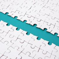 The blue path is laid on the platform of a white folded jigsaw puzzle. Texture image with copy space for text photo