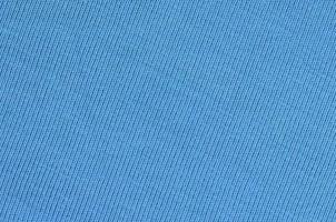 The texture of the fabric in blue color. Material for making shirts and blouses photo