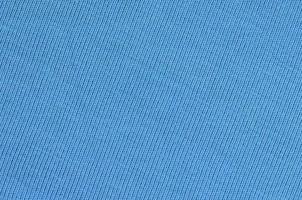 The texture of the fabric in blue color. Material for making shirts and blouses photo