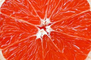 Top view of a fragment of the grapefruit slice close up. Macro background texture photo