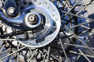 Fragment of chromed shiny wheel of old classic motorbike photo