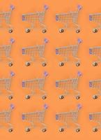 Shopping addiction, shopping lover or shopaholic concept. Many small empty shopping carts perform a pattern on a pastel colored paper background. Flat lay composition, top view photo