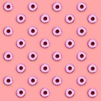 Many small plastic donuts lies on a pastel colorful background. Flat lay minimal pattern. Top view photo