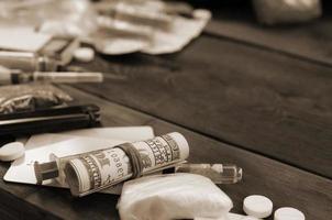 A lot of narcotic substances and devices for the preparation of drugs lie on an old wooden table photo