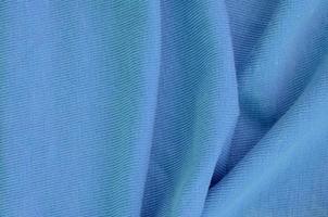 The texture of the fabric in blue color. Material for making shirts and blouses photo