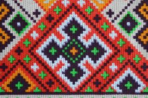 Traditional Ukrainian folk art knitted embroidery pattern on textile fabric photo