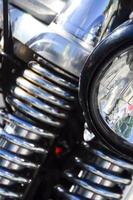 Fragment of chromed shiny lamp of old classic motorbike photo