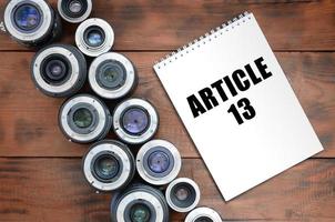 Two photographic lenses and notebook with article 13 inscription photo